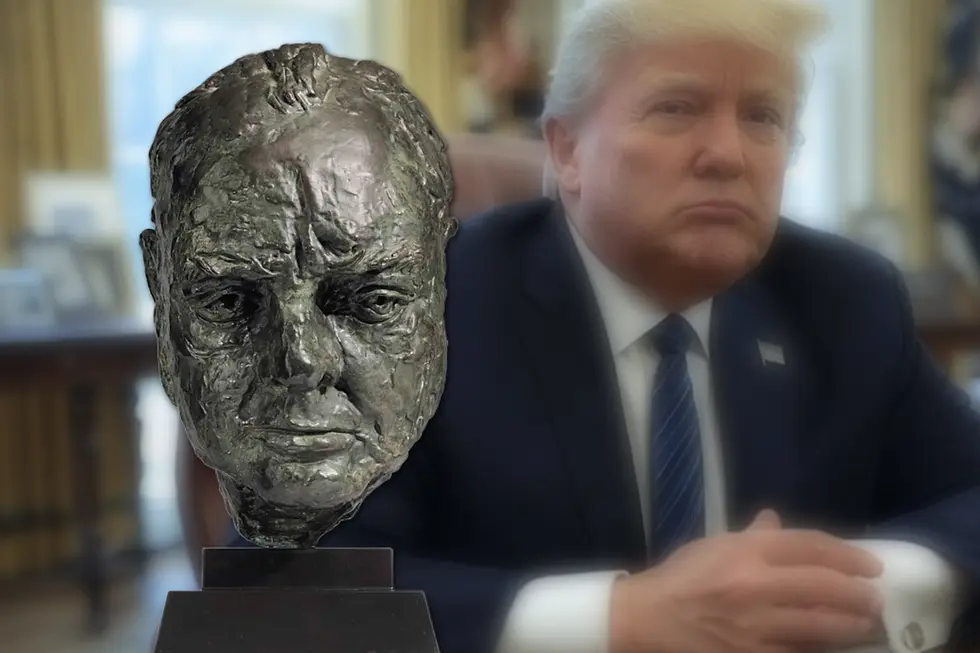 Donald Trump seated beside a bust of Winston Churchill in the Oval Office