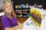 Owner and artist, Mary paints the skyline of Charlotte, N.C.