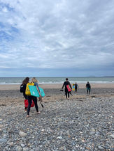 Bodyboarders walking to the sea at Hell's Mouth