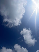 the clouds and the sun above Llanbedrog Beach