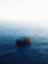 beautiful-vertical-shot-brown-rock-middle-sea-with-amazing-water-textures.jpg