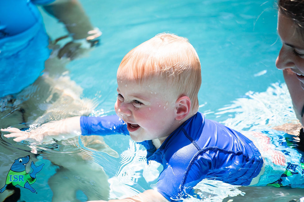 Eye-level view of a child happily swimming in a pool during a lesson