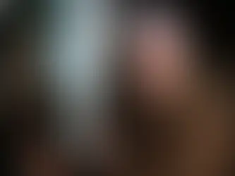 Peter Vincent in Fright Night (1985), standing in front of a window, holding a cross for protection. On the other side of the window we can see Jerry Dandrige in his vampire form, planning on attacking Peter.