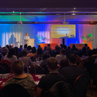 A speaker giving a talk at the Reach weekend