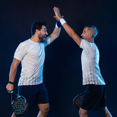 padel players high-fiving