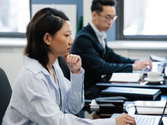 2 people working next to each other