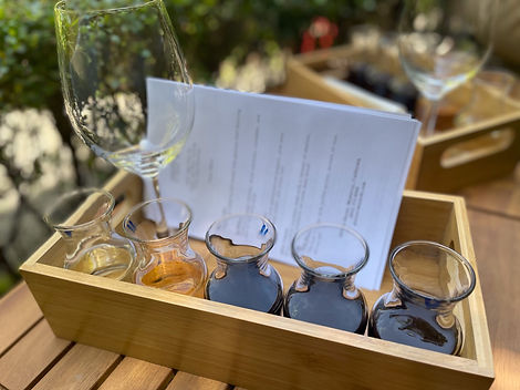 Pierce Ranch Vineyards wine tasting menu and carafes placed uniquely in a wooden tray