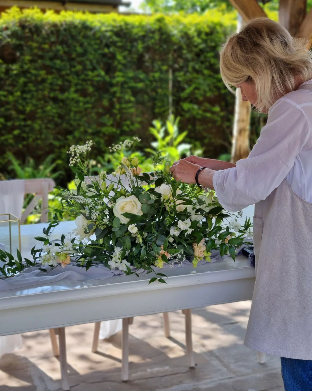 Julie finishing a long and low floral arrangement
