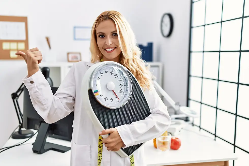 beautiful-blonde-nutritionist-woman-holding-weight-machine-balance-weight-loss-pointing-th