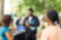 two people standing outside communicating using sign language