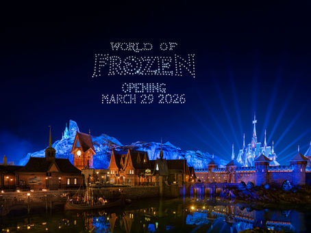 The village of Arandelle lit up at night with drones showing the message: World of Frozen, Opening March 29th 2026