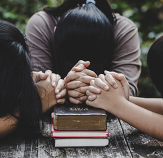 women-praying-together