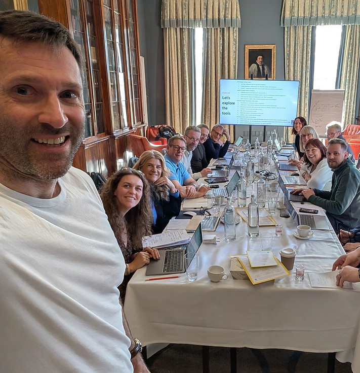 Participants gathered around a table during an in-person AI Leadership Strategy Day session