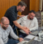 Attendees collaborating on laptops to explore practical AI use cases during an AI Value Discovery Day
