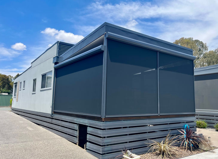 Cabin with Ziptrak® blinds installed, offering weather protection and privacy.