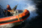 United States Coast Guard boat with boatswains mate gunner's mate with machine gun.