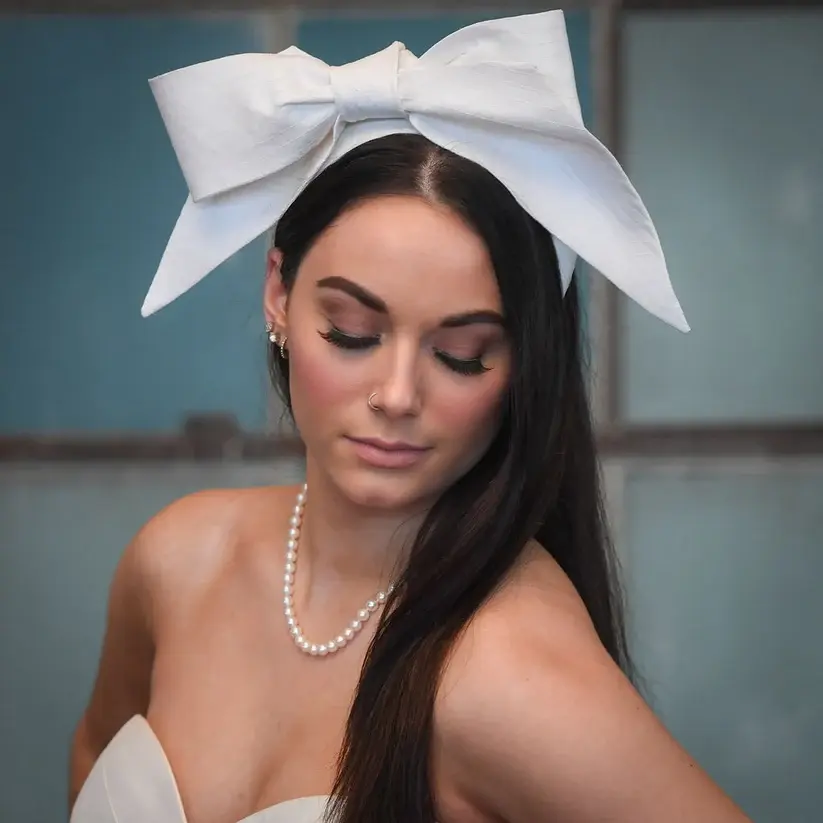 a bride wearing a over sized bridal bow