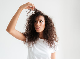 portrait-confused-young-woman-looking-her-hair.jpg