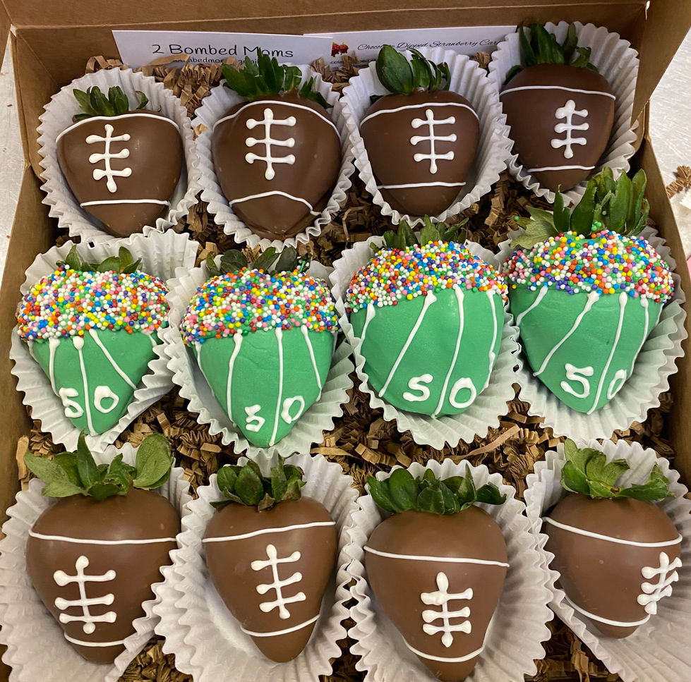 a box of chocolate covered strawberries decorated to look like footballs