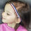 Thumbnail: Young girl wearing red, white, blue headband with hearing aid, Michela Design Canada.