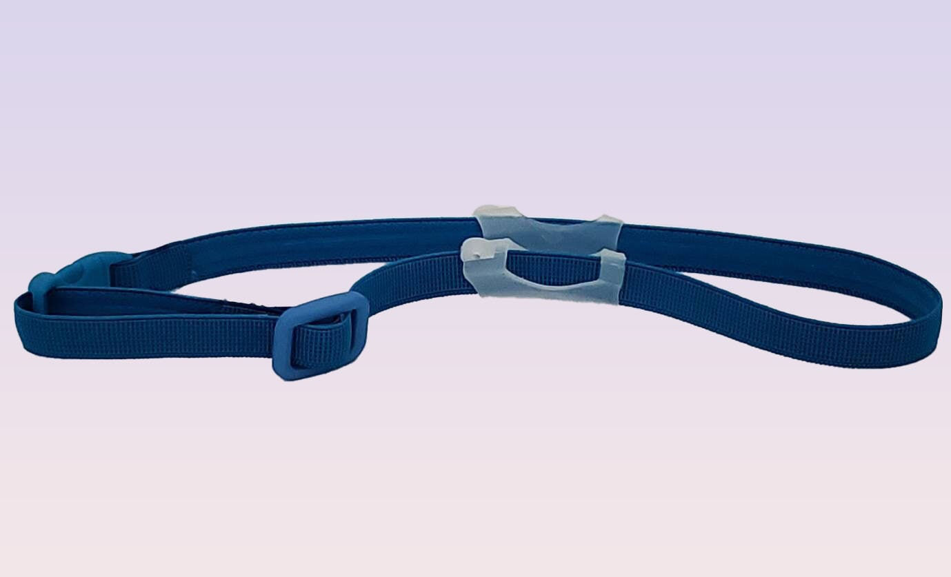 Blue hearing aid strap with adjustable buckle against a gradient background.