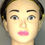 Thumbnail: A mannequin head with headband and light skin, pink lips and grey eyes.