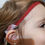 Thumbnail: Young girl wearing a red headband with an Adjustable Hearing Aid Headband.