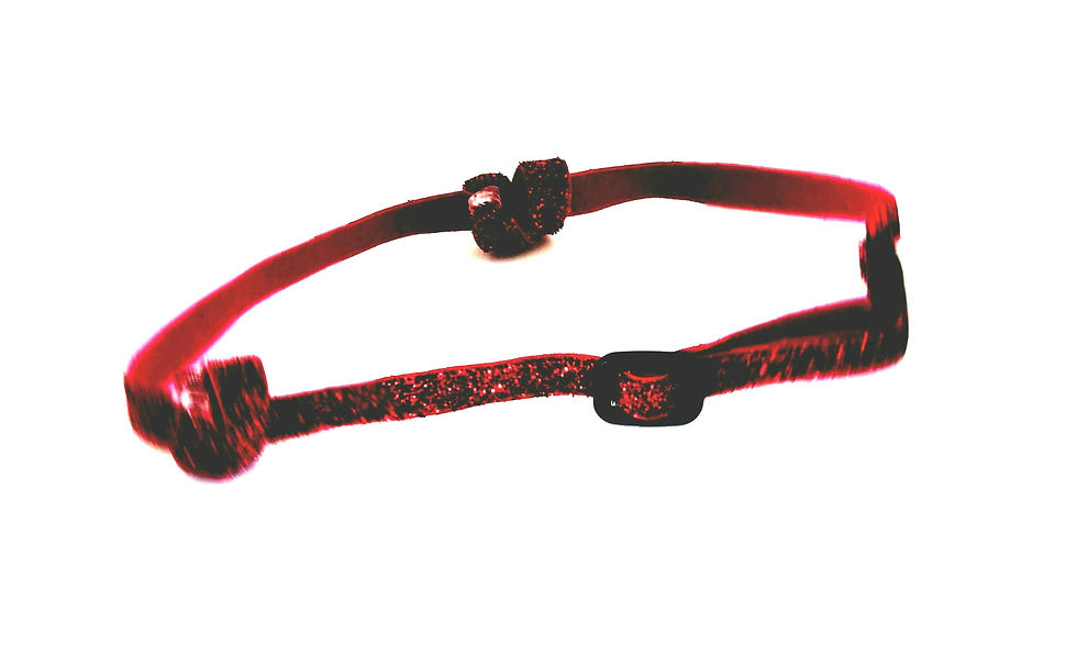 Red headband with black clasps and knots on a white background.