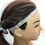 Thumbnail: Headband with hearts on mannequin head. Orange glitter cochlear headband adds sparkle.