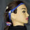 Thumbnail: Head model with a blue headband and hearing aid, side profile view.