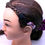 Thumbnail: Head model with a braided hairstyle, Baha headband, and purple hair tie.