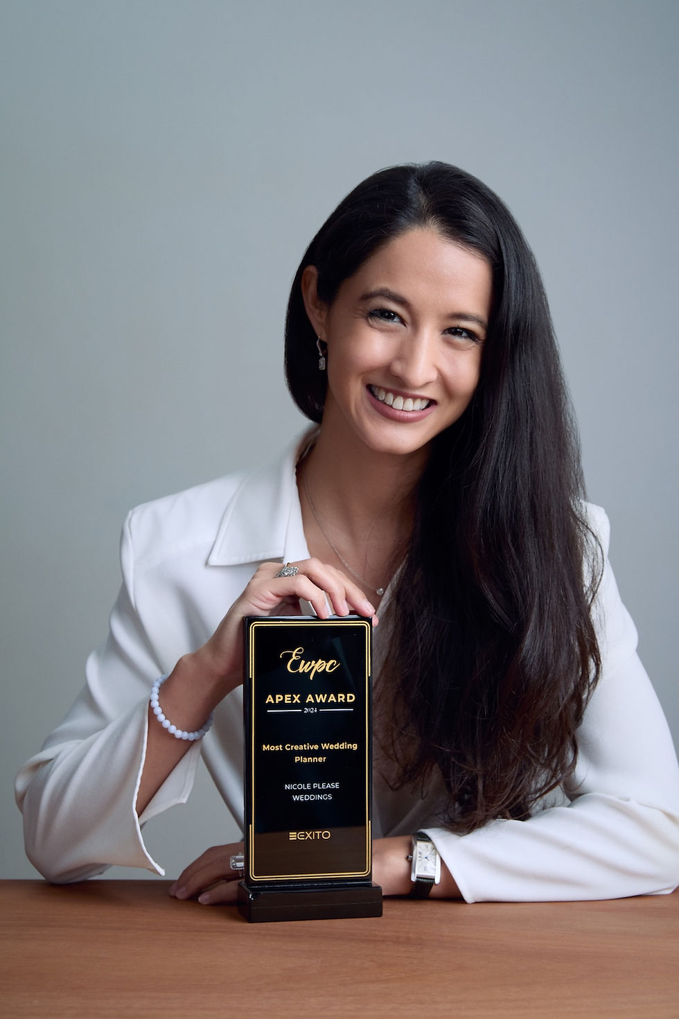 Nicole Froelich receiving World's best wedding planner award, highlighting her expertise in luxury destination and multicultural weddings at Nicole Please Weddings