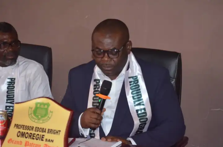 Prof. Edoba Bright Omoregie, SAN, holding his Grand Patron plaque