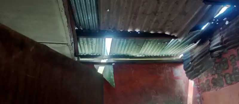 The bare roofing sheets inside the old block