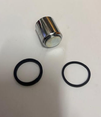 Chrome motorcycle part and two black O-rings on white background. Malcsmotorbikespares