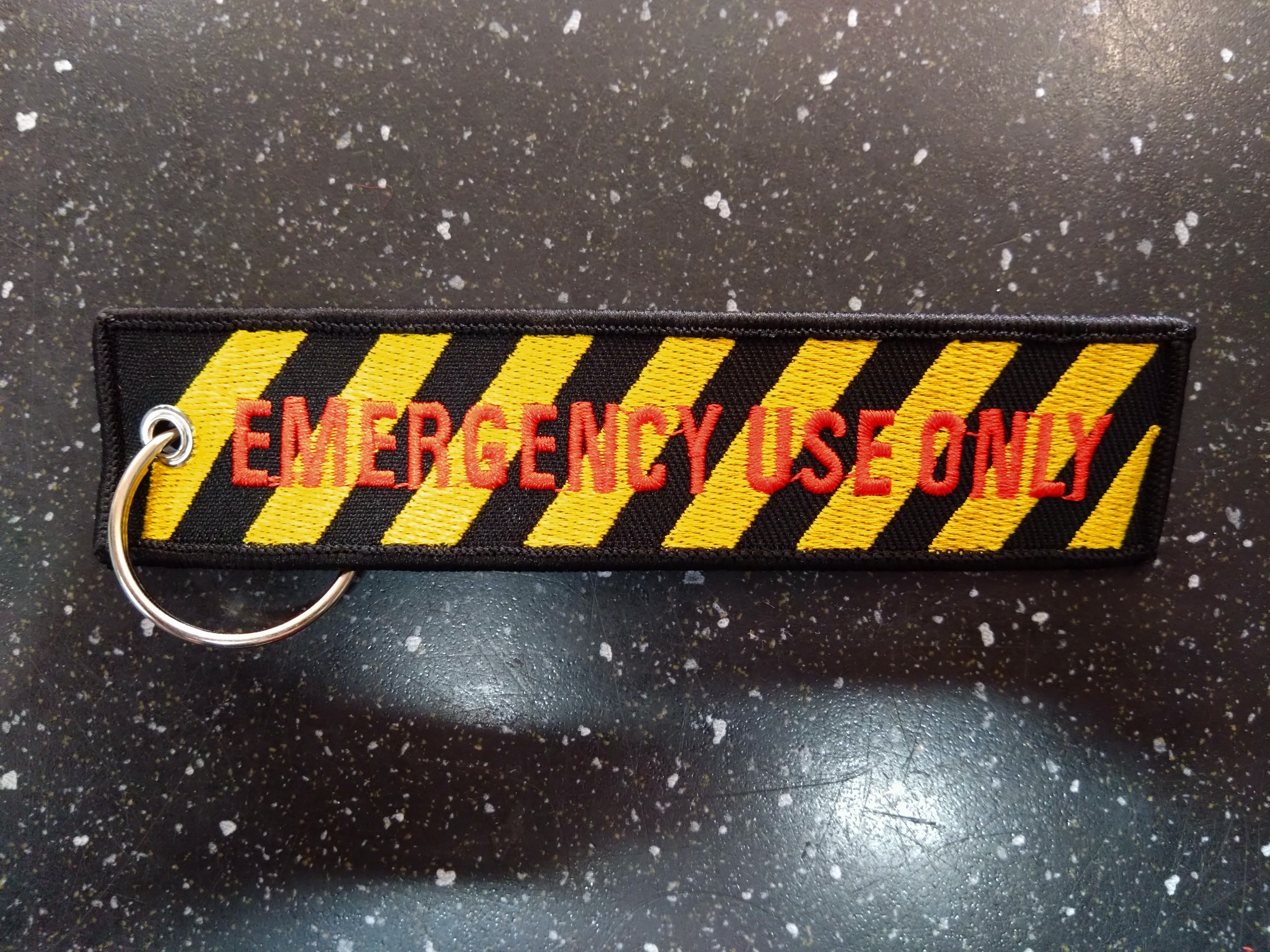 Emergency Use Only keychain with yellow and black stripes Malcsmotorbikespares