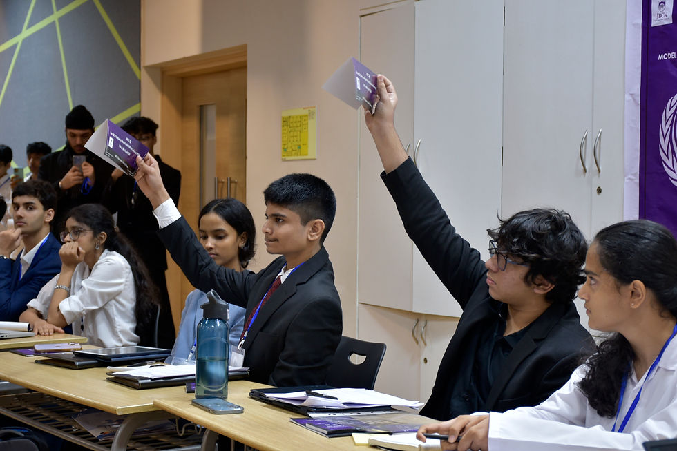 Picture of Multiple Delegates raising enthusiastically cards to speak and debate