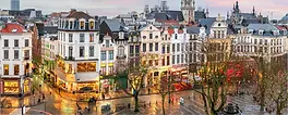 Brussels: elevated view of a square lined with ornate townhouses at dusk.