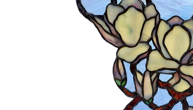 Three magnolia flowers and one magnolia bud rendered in stained glass.