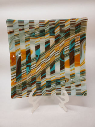A fascinating and gorgeous platter, made with alternating strips of swirled baroque glass. 12" square.

Available for sale in the shop.