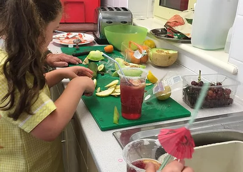 Children preparing fruit.
