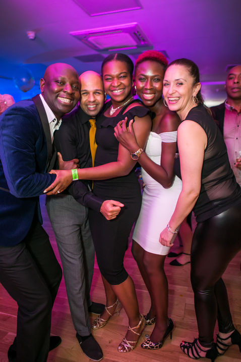 A group of friends posing for a picture at a Kizomba party