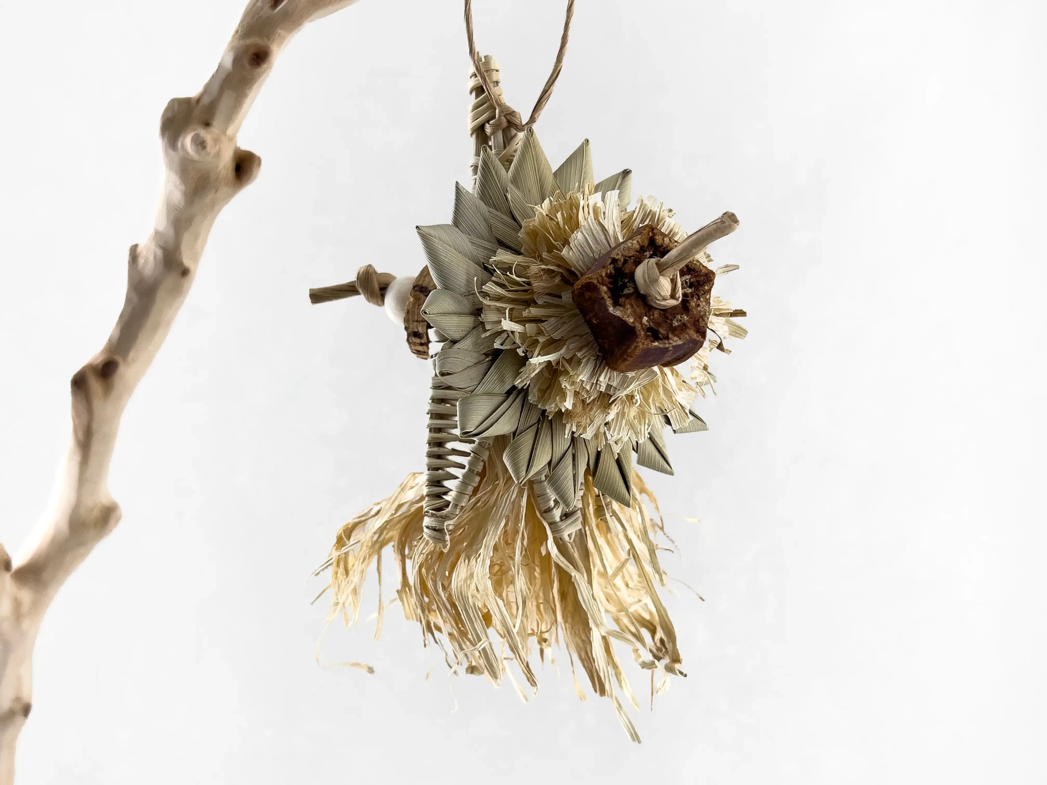 Handmade foraging toy for small birds featuring a wood vine flower, cork, corn husk, mahogany pod; dye-free and plastic-free.
