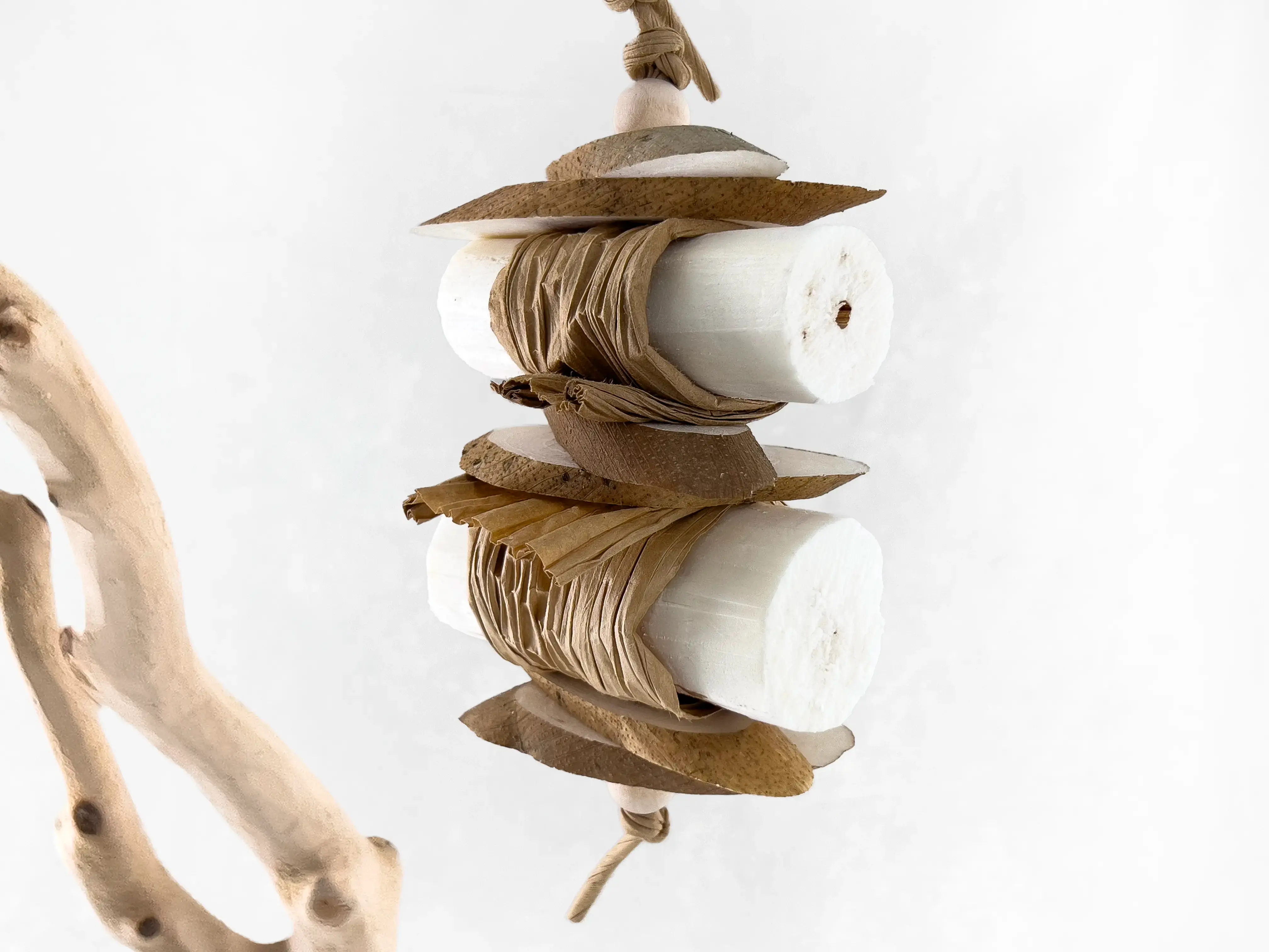 Small bird toy and parrot shredding toy made of soft sola wood logs and paper.
