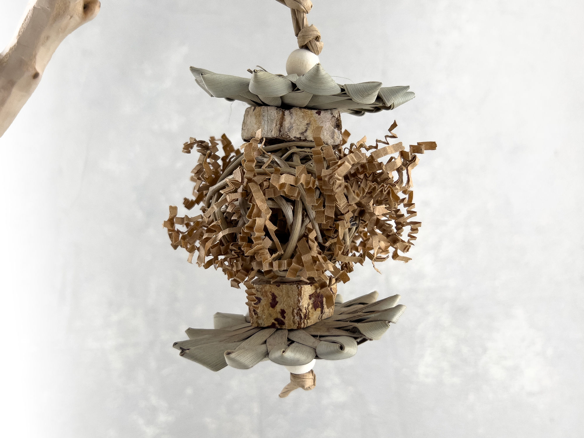 Small bird toy and natural foraging parrot toy made of mahogany pod, palm, vine ball stuffed with crinkle paper, wood beads.