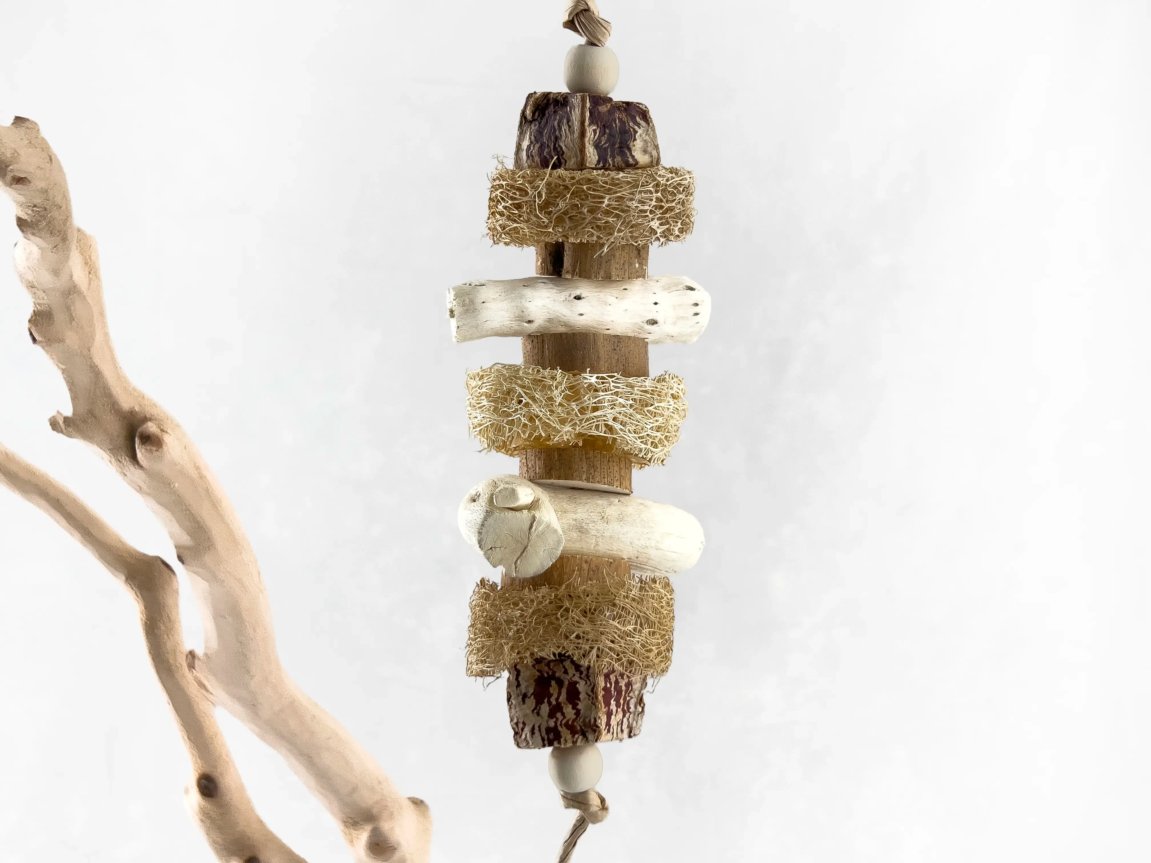 All natural bird shredder toy and parrot chew toy made of mahogany pod slices, loofah, gobi tail, sola slices, wood beads.