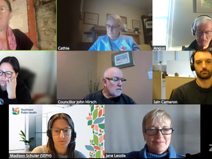 Video call with eight participants in separate panels. Some wear headphones, engaged in conversation. Backgrounds include home offices.