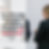 A woman in a suit holding a tablet stands in focus, with blurred colleagues and laptops in the background. Text reads: "The Condominium Authority Tribunal Decides that Video Recordings of AGMs are NOT Records... Again?"