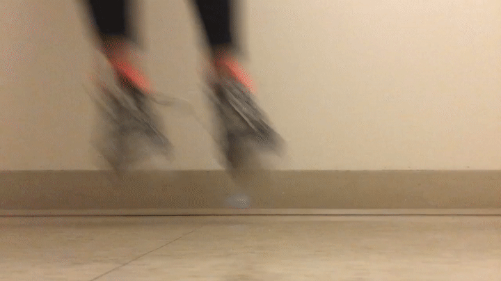 Black converse sneakers with bright pink socks.
