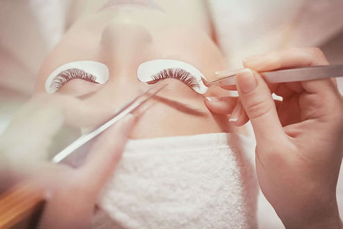 Woman receiving full set eyelash extensions